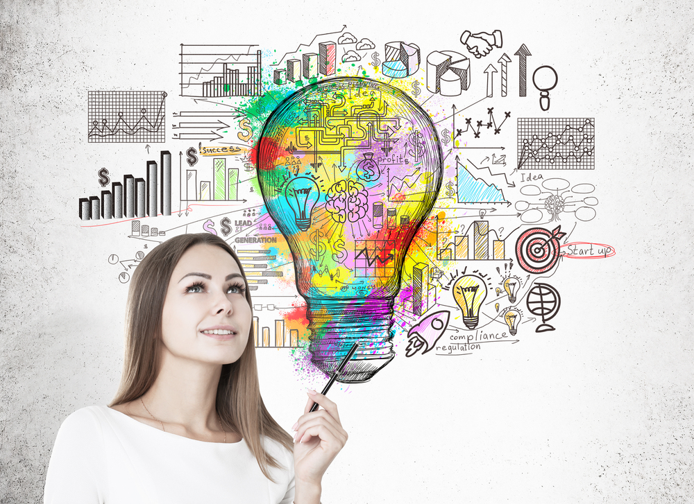 Woman with pen and colorful light bulb - representing thought leadership strategy